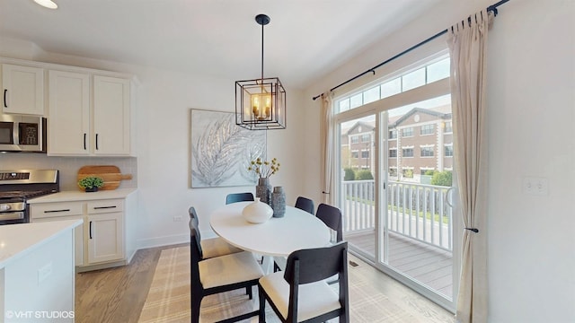 405 Filson St, La Grange, IL 60525 - dining room featuring light wood-style floors, baseboards, and an inviting chandelier
