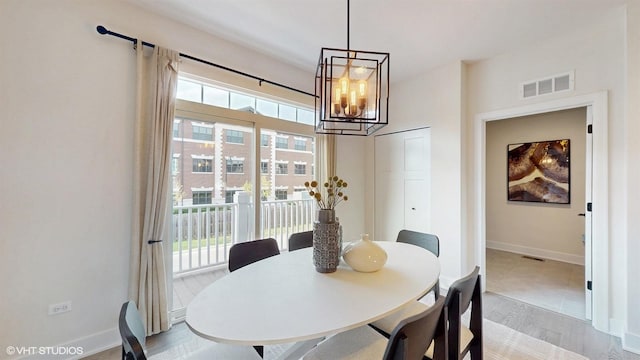 405 Filson St, La Grange, IL 60525 - dining room featuring visible vents, light wood-type flooring, baseboards, and an inviting chandelier