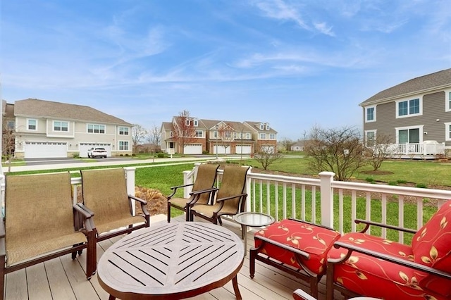 deck featuring a lawn and a residential view