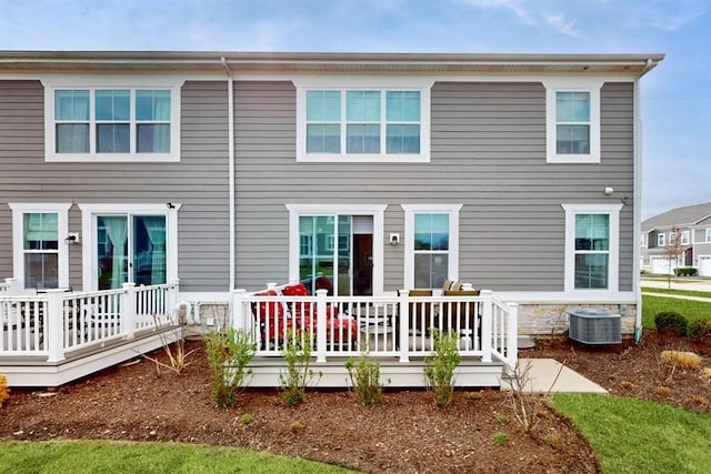 rear view of property featuring central AC unit and a deck