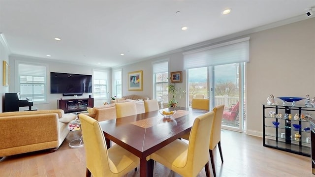 dining room featuring ornamental molding, baseboards, recessed lighting, and light wood-style floors