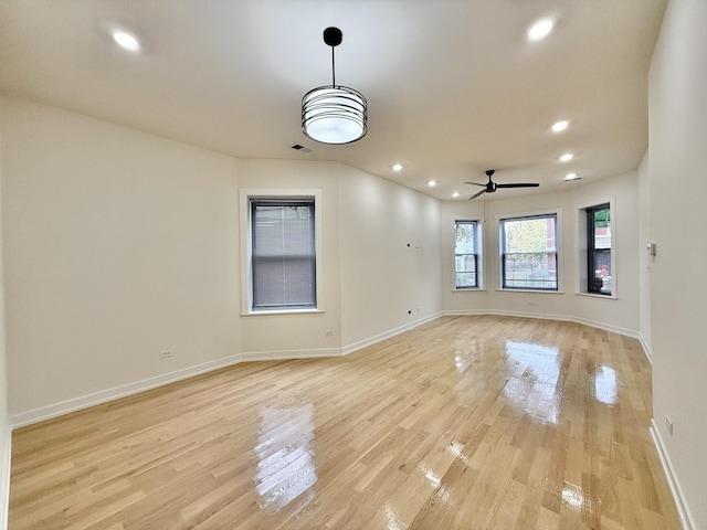 spare room featuring light wood-style flooring, a ceiling fan, visible vents, recessed lighting, and baseboards