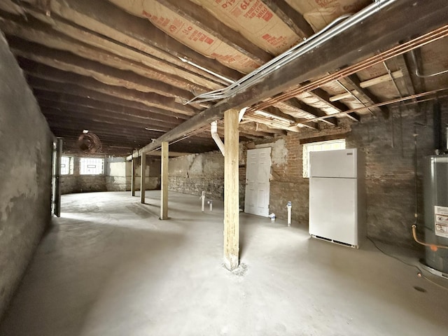 below grade area with freestanding refrigerator and water heater