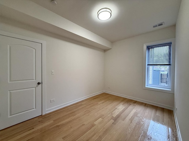additional living space featuring light wood-style flooring, baseboards, and visible vents