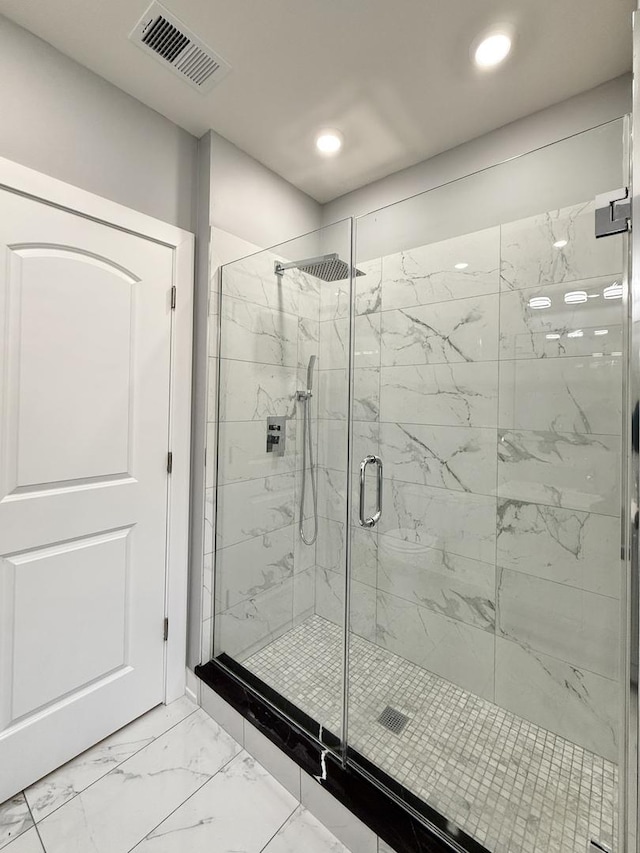bathroom featuring a marble finish shower, visible vents, recessed lighting, and marble finish floor