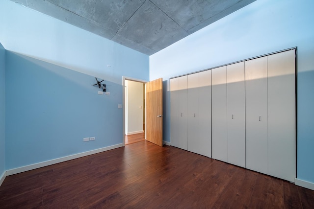 unfurnished bedroom with baseboards and wood finished floors