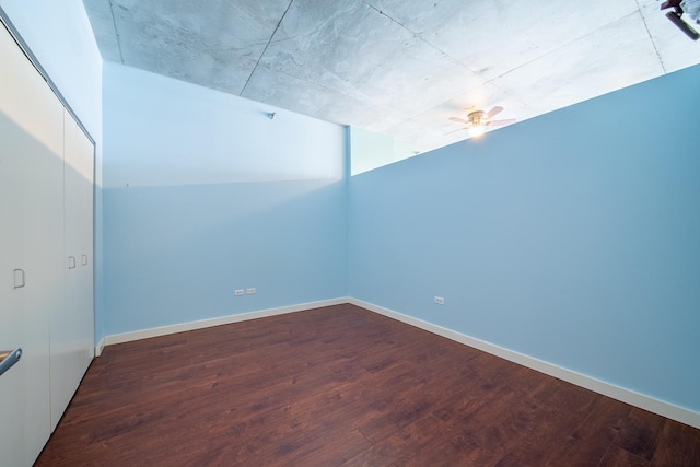 unfurnished room with wood finished floors, ceiling fan, and baseboards
