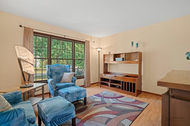 living room featuring baseboards and light wood-style flooring