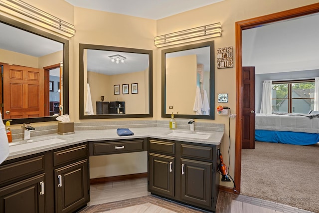 full bathroom featuring connected bathroom, a sink, and double vanity