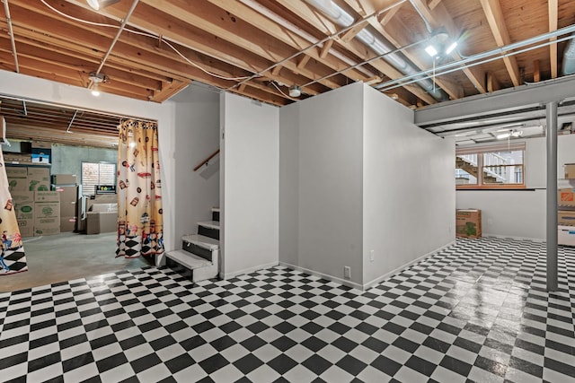 basement featuring tile patterned floors, stairway, and a healthy amount of sunlight