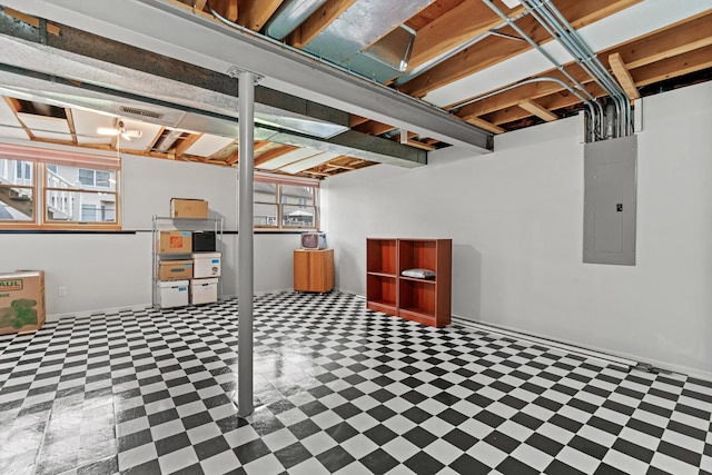 below grade area featuring electric panel and tile patterned floors