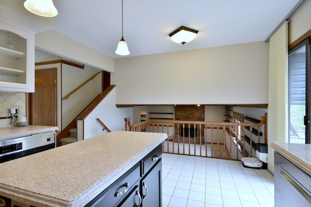 1167 Timberlane Ct, Naperville, IL 60540 - kitchen with light tile patterned flooring, light countertops, decorative backsplash, pendant lighting, and glass insert cabinets
