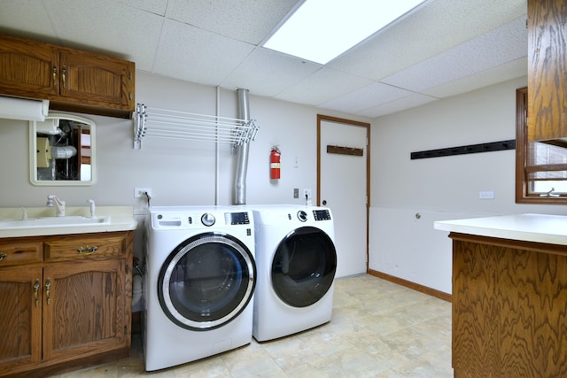 1167 Timberlane Ct, Naperville, IL 60540 - laundry area with washing machine and clothes dryer, baseboards, a sink, and cabinet space