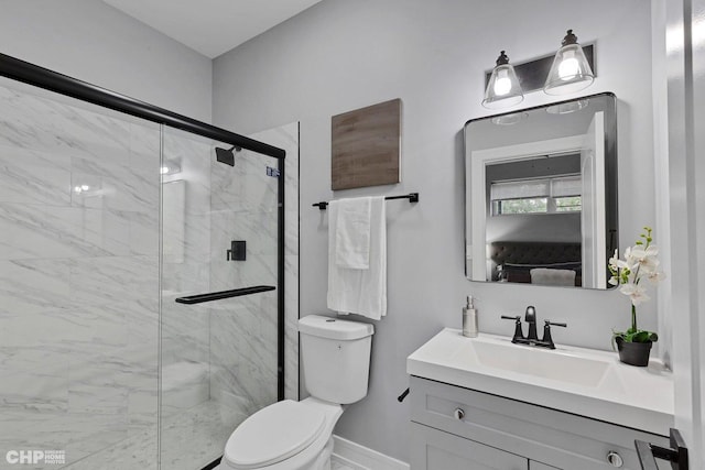 bathroom featuring toilet, vanity, baseboards, and a marble finish shower