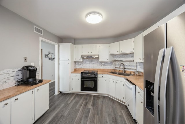 kitchen with a sink, dishwasher, black electric range, under cabinet range hood, and stainless steel refrigerator with ice dispenser