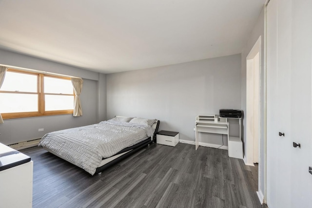 bedroom featuring a baseboard radiator and dark wood finished floors