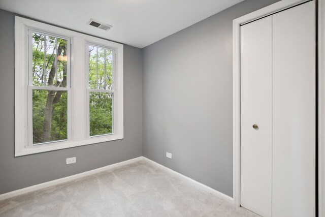 135 Cora Ave, Fox Lake, IL 60020 - unfurnished bedroom with baseboards, carpet, and a closet