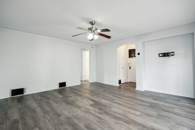 135 Cora Ave, Fox Lake, IL 60020 - spare room with arched walkways, ceiling fan, and wood finished floors
