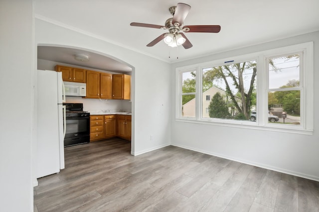 135 Cora Ave, Fox Lake, IL 60020 - kitchen featuring white appliances, brown cabinets, light wood-type flooring, light countertops, and a ceiling fan