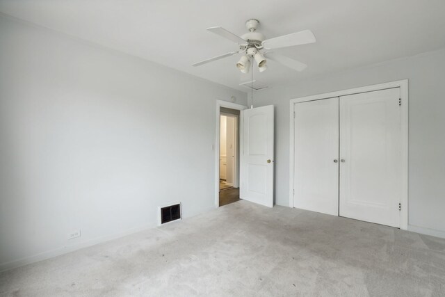 135 Cora Ave, Fox Lake, IL 60020 - unfurnished bedroom featuring carpet, a closet, ceiling fan, attic access, and baseboards