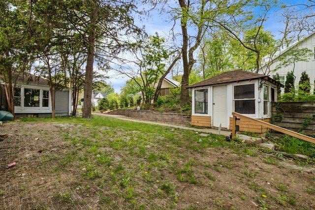 135 Cora Ave, Fox Lake, IL 60020 - view of yard featuring fence and an outbuilding