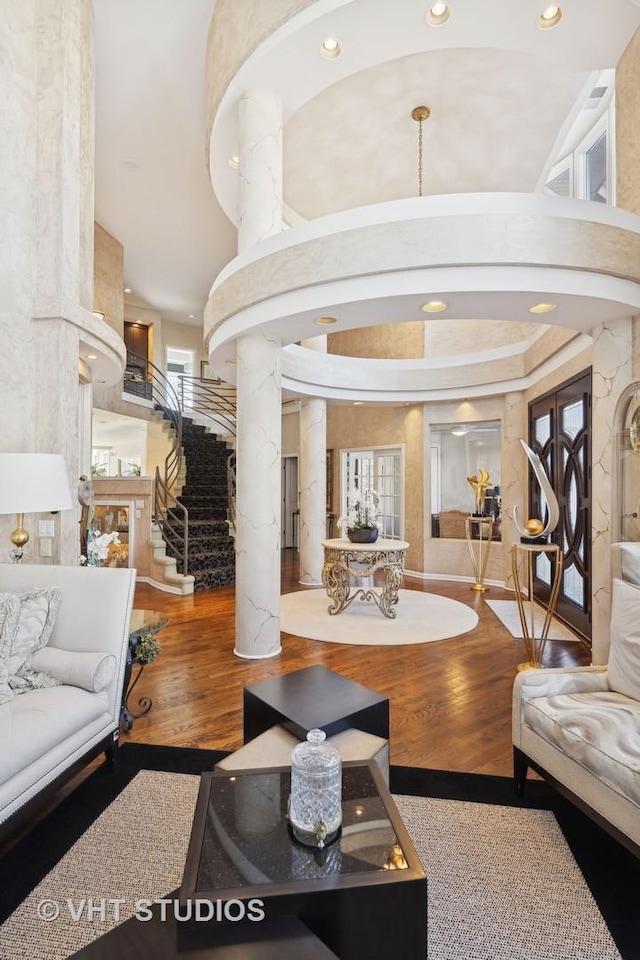 1525 Woodcrest Ct, Aurora, IL 60502 - foyer entrance with arched walkways, wood finished floors, a towering ceiling, and decorative columns