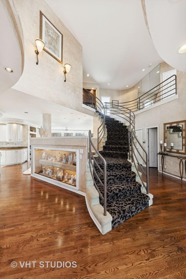 1525 Woodcrest Ct, Aurora, IL 60502 - staircase with baseboards, a high ceiling, carpet floors, and recessed lighting