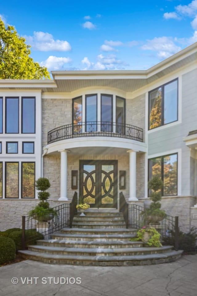 1525 Woodcrest Ct, Aurora, IL 60502 - contemporary house with driveway, stone siding, and a balcony