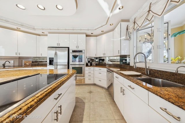 1525 Woodcrest Ct, Aurora, IL 60502 - kitchen with a kitchen breakfast bar, a warming drawer, dark countertops, white cabinetry, and light tile patterned floors