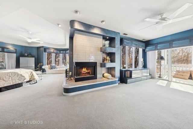 1525 Woodcrest Ct, Aurora, IL 60502 - unfurnished bedroom featuring lofted ceiling, visible vents, and carpet