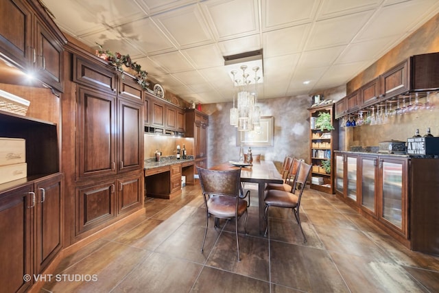 1525 Woodcrest Ct, Aurora, IL 60502 - dining space with an ornate ceiling, a chandelier, and dark tile patterned flooring