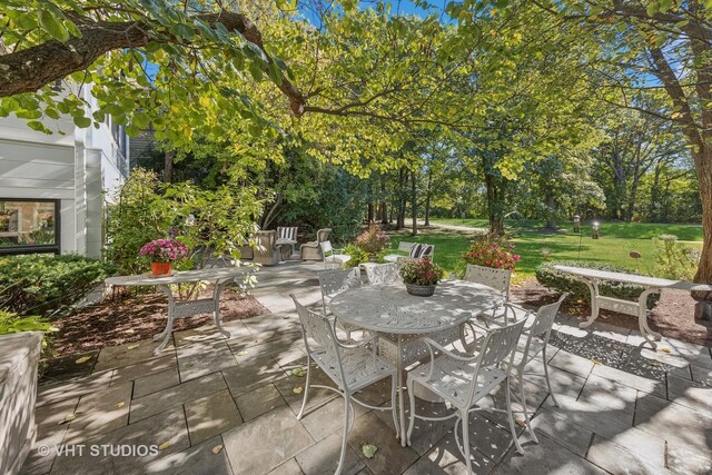 1525 Woodcrest Ct, Aurora, IL 60502 - sunroom / solarium with crown molding, a baseboard heating unit, a chandelier, baseboards, and stone finish floor