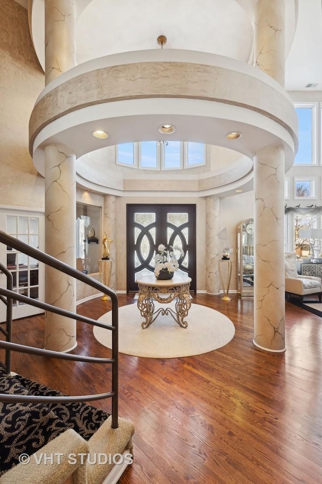 1525 Woodcrest Ct, Aurora, IL 60502 - interior space featuring stairway, wood finished floors, a towering ceiling, and ornate columns