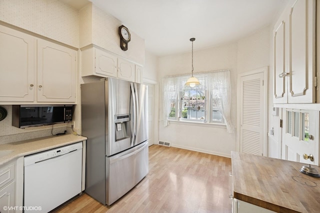 607 Thatcher Ave, River Forest, IL 60305 - kitchen featuring stainless steel refrigerator with ice dispenser, visible vents, black microwave, dishwasher, and light wood-style floors