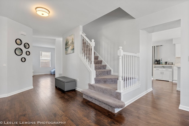 stairway with wood finished floors and baseboards