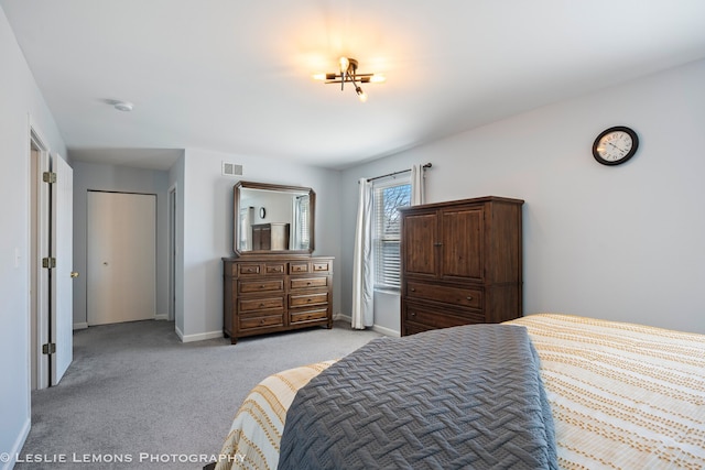 bedroom featuring light carpet, visible vents, and baseboards
