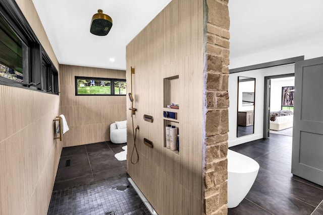 full bathroom with tile patterned floors and a freestanding bath