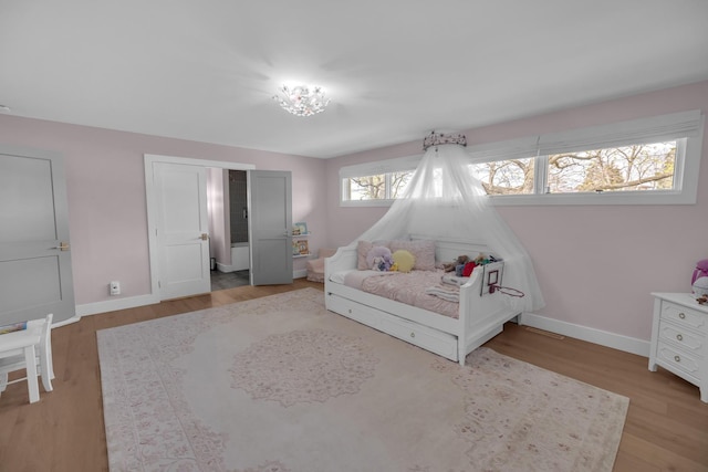 bedroom with wood finished floors and baseboards