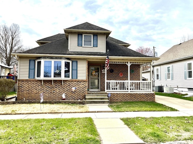 bungalow with brick siding, central AC, and covered porch