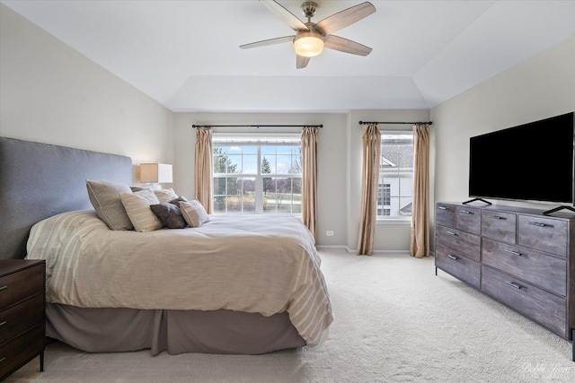 bedroom with vaulted ceiling, a ceiling fan, baseboards, and light carpet