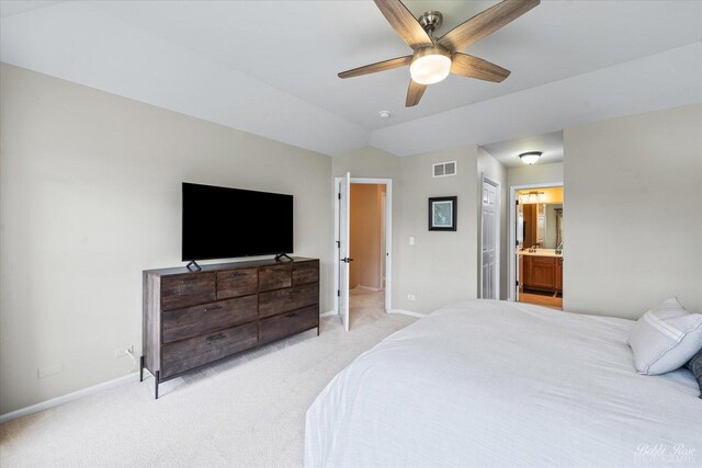 bedroom with connected bathroom, light carpet, visible vents, and baseboards