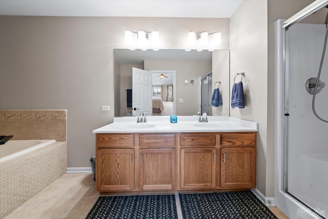full bath featuring tile patterned floors, connected bathroom, a shower stall, and double vanity