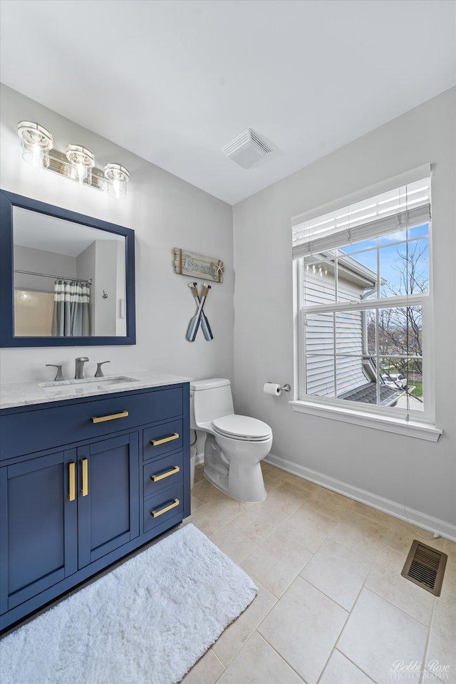 full bathroom featuring toilet, vanity, tile patterned floors, and visible vents
