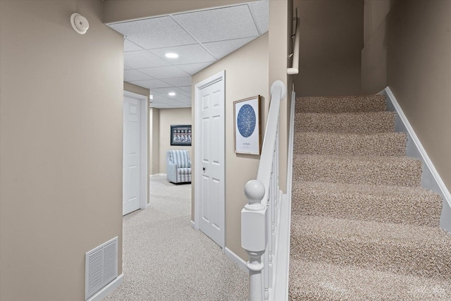 stairway with a paneled ceiling, baseboards, visible vents, recessed lighting, and carpet floors