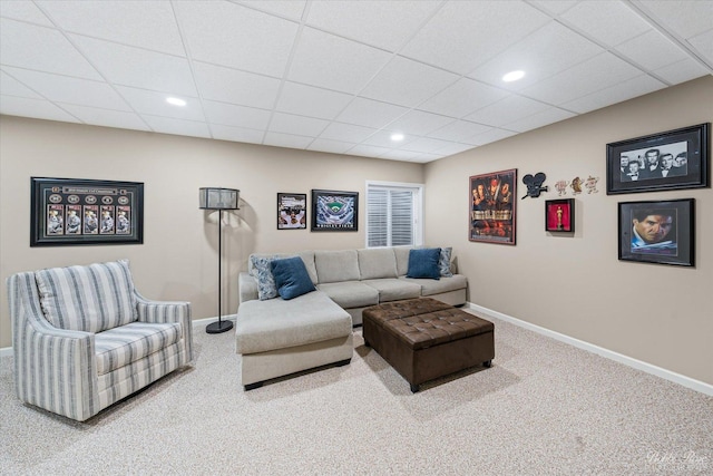 carpeted living room featuring a paneled ceiling, baseboards, and recessed lighting
