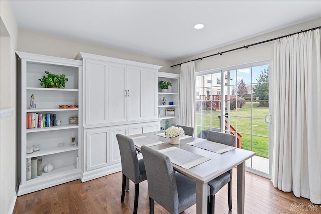 dining space with wood finished floors and recessed lighting