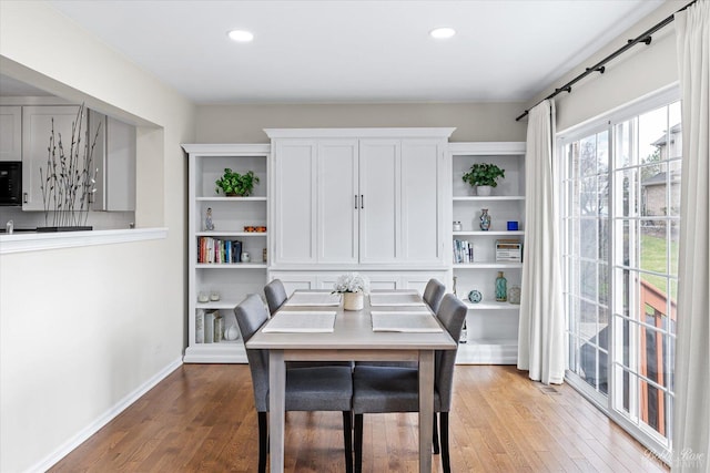 dining space with recessed lighting, wood finished floors, and baseboards