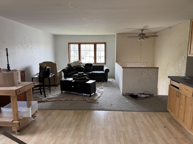 living room with ceiling fan and light wood finished floors
