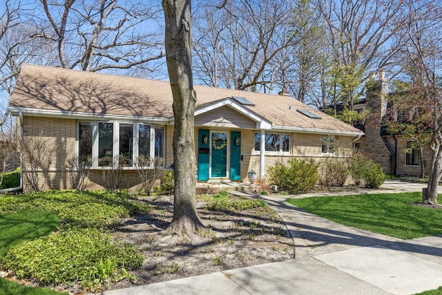 3528 Forest Ave, Wilmette, IL 60091 - single story home featuring brick siding, a front yard, and roof with shingles
