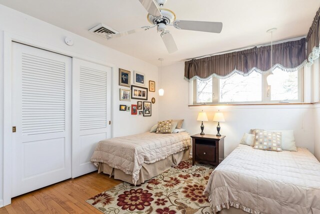 3528 Forest Ave, Wilmette, IL 60091 - bedroom featuring ceiling fan, wood finished floors, visible vents, and a closet